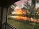 Beautiful sunset view from the lanai, featuring a vibrant sky reflecting on the lake at 3609 Azurite Ct, Deland, FL 32724