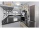 Stylish kitchen with stainless steel appliances, granite countertops, and gray cabinetry at 451 Hibiscus Rd, Casselberry, FL 32707
