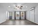 Bright living room with vinyl floors, ceiling fan, and windows with modern curtains at 451 Hibiscus Rd, Casselberry, FL 32707