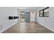 Bright, open living room featuring new floors, modern lighting, and large windows at 451 Hibiscus Rd, Casselberry, FL 32707