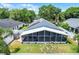 Aerial view of the fenced backyard with a screened-in patio and tropical landscaping at 578 Darkwood Ave, Ocoee, FL 34761