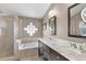 This bathroom offers a glass enclosed shower, tub, double sink vanity and decorative wall art at 578 Darkwood Ave, Ocoee, FL 34761