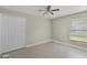 This bedroom features neutral walls, a window for natural light and a ceiling fan at 578 Darkwood Ave, Ocoee, FL 34761