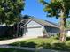 Side view of a one-story home with a well-maintained lawn and an attached two-car garage at 578 Darkwood Ave, Ocoee, FL 34761
