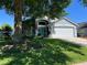 Charming single-Gathering home featuring a manicured lawn and a beautiful turquoise front door at 578 Darkwood Ave, Ocoee, FL 34761