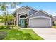 Charming home featuring a well-manicured lawn and a bright, inviting turquoise front door at 578 Darkwood Ave, Ocoee, FL 34761