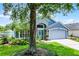 Attractive exterior with lush lawn, palm trees, and a striking turquoise front door at 578 Darkwood Ave, Ocoee, FL 34761