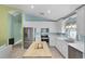 Bright kitchen featuring white cabinetry, an island, and stainless steel appliances at 578 Darkwood Ave, Ocoee, FL 34761