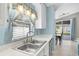 Bright kitchen with white cabinetry and stainless steel appliances overlooking backyard at 578 Darkwood Ave, Ocoee, FL 34761