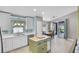 Bright kitchen with white cabinets, stainless steel appliances, and center island at 578 Darkwood Ave, Ocoee, FL 34761