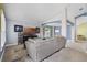 Spacious living room with large sofa and entertainment center at 578 Darkwood Ave, Ocoee, FL 34761