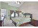 This main bedroom features a vaulted ceiling, a large window and access to screened porch at 578 Darkwood Ave, Ocoee, FL 34761