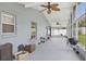 Spacious screened porch featuring multiple ceiling fans and access to the backyard at 578 Darkwood Ave, Ocoee, FL 34761