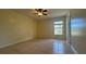 Bedroom with tile flooring, ceiling fan, and natural light from the window at 6654 Hiawassee Meadows Dr, Orlando, FL 32818