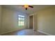 Bedroom featuring a window, closet with bi-fold doors, ceiling fan, and neutral paint at 6654 Hiawassee Meadows Dr, Orlando, FL 32818