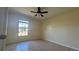 Bedroom with tile flooring, ceiling fan, and a window offering natural light at 6654 Hiawassee Meadows Dr, Orlando, FL 32818