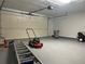 Spacious garage featuring epoxy flooring, overhead door and garage door opener at 6654 Hiawassee Meadows Dr, Orlando, FL 32818