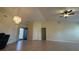 Bright living room showcasing tile flooring, vaulted ceiling and modern light fixture at 6654 Hiawassee Meadows Dr, Orlando, FL 32818