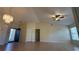 Spacious living room featuring tile flooring, ceiling fan and vaulted ceiling with lots of light at 6654 Hiawassee Meadows Dr, Orlando, FL 32818