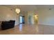 Spacious living room with tile flooring, neutral walls, and a decorative chandelier at 6654 Hiawassee Meadows Dr, Orlando, FL 32818