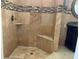 Tiled walk-in shower featuring a built in bench and stone tile accents at 702 Palenci Ct, Winter Springs, FL 32708
