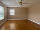 Spacious bedroom with hardwood floors, a ceiling fan, neutral paint, and a bright window at 702 Palenci Ct, Winter Springs, FL 32708