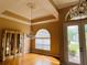 A dining room featuring an elegant chandelier, hardwood flooring, and a large window at 702 Palenci Ct, Winter Springs, FL 32708