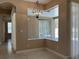 A dining room featuring decorative lighting and windows to a screened lanai at 702 Palenci Ct, Winter Springs, FL 32708