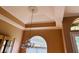 Elegant dining room with tray ceilings, chandelier, and arched window for natural light at 702 Palenci Ct, Winter Springs, FL 32708