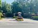 Gated community entrance with brick pillars, manicured landscaping, and secure access at 702 Palenci Ct, Winter Springs, FL 32708