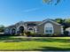 Well-manicured lawn and landscaping enhance the curb appeal of this home at 702 Palenci Ct, Winter Springs, FL 32708