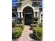 Charming front entrance with manicured bushes and a brick walkway at 702 Palenci Ct, Winter Springs, FL 32708