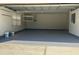 Spacious garage with a freshly painted floor, ideal for parking and storage at 702 Palenci Ct, Winter Springs, FL 32708