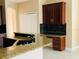 Modern kitchen features granite countertops, wooden cabinets and stainless steel appliances at 702 Palenci Ct, Winter Springs, FL 32708