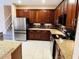 Well equipped kitchen with tile flooring, stainless steel appliances and wood cabinets at 702 Palenci Ct, Winter Springs, FL 32708