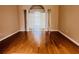 Spacious living area with gleaming hardwood floors and elegant archway at 702 Palenci Ct, Winter Springs, FL 32708