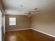 Spacious living room with hardwood floors, a ceiling fan, and natural light from the window at 702 Palenci Ct, Winter Springs, FL 32708