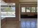 Living room with view of pool area through large windows, and tile flooring at 702 Palenci Ct, Winter Springs, FL 32708