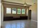 Living room features neutral paint, tile floor and large windows overlooking the pool at 702 Palenci Ct, Winter Springs, FL 32708