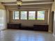 A living room featuring a wall of windows overlooking the pool, and built-in cabinets at 702 Palenci Ct, Winter Springs, FL 32708