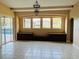Bright living room with tile floors, built-in storage, and a view of the pool at 702 Palenci Ct, Winter Springs, FL 32708