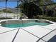 Tranquil screened-in pool area with tiled accents and ample deck space for entertaining and relaxation at 702 Palenci Ct, Winter Springs, FL 32708