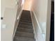 A stairway featuring carpeted stairs and a handrail at 702 Palenci Ct, Winter Springs, FL 32708