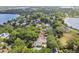 Expansive aerial shot of a leafy residential area with houses nestled among mature trees and lakes at 755 Cranes Court, Maitland, FL 32751