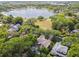 Aerial view of a beautiful home surrounded by lush greenery with a lake in the distance at 755 Cranes Court, Maitland, FL 32751