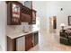 Home wet bar with marble countertop, wine storage, and bar fridge, great for entertaining guests at 755 Cranes Court, Maitland, FL 32751