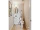 Powder room features a pedestal sink, a stylish mirror and framed artwork at 755 Cranes Court, Maitland, FL 32751