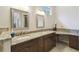 Elegant bathroom featuring double sinks, granite countertops, and decorative mirrors at 755 Cranes Court, Maitland, FL 32751