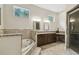 Primary bathroom featuring a soaking tub, granite counters, double sinks, and glass shower at 755 Cranes Court, Maitland, FL 32751