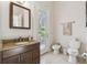 Well-lit bathroom featuring a marble vanity top, and neutral walls and fixtures at 755 Cranes Court, Maitland, FL 32751